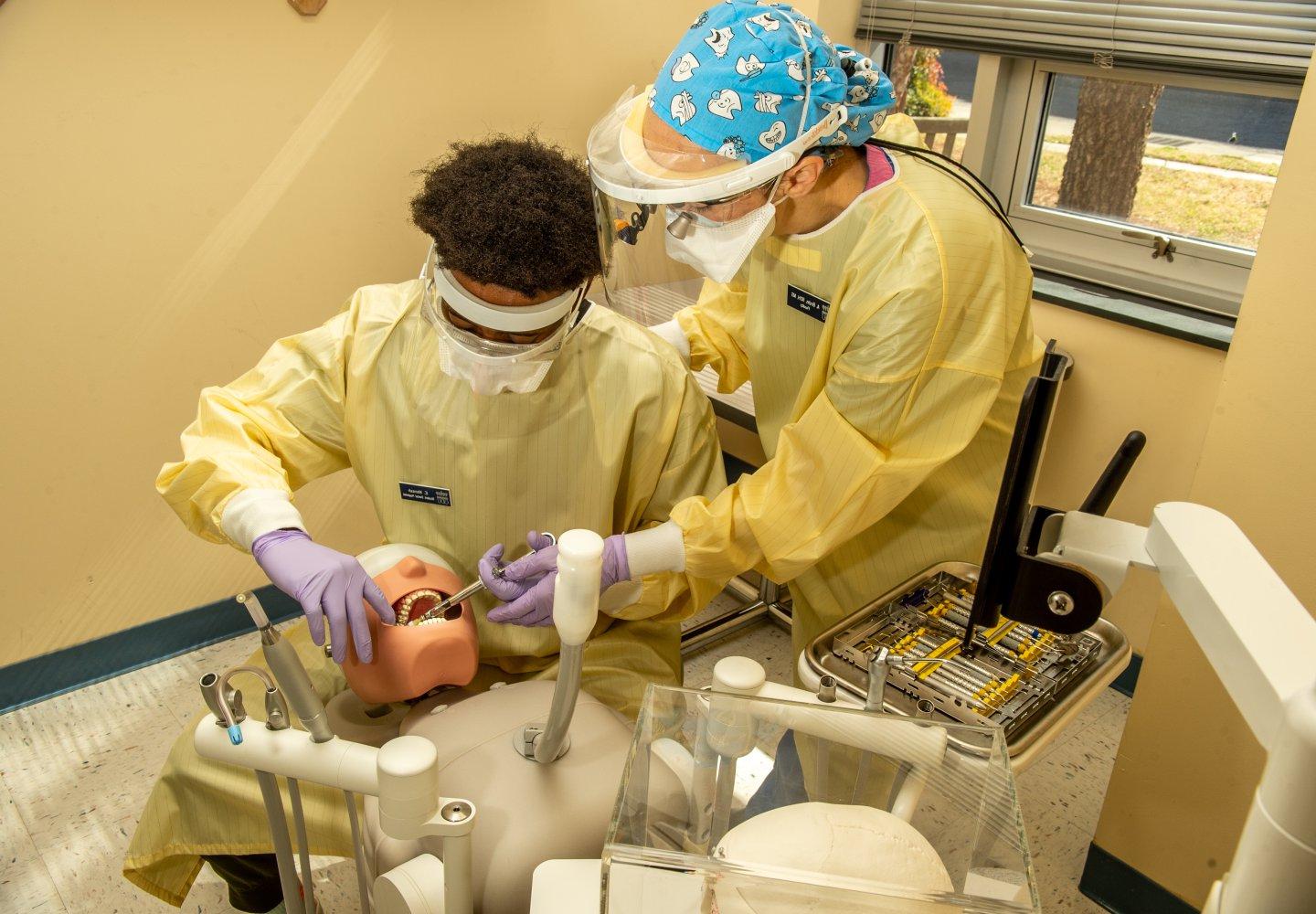 Dental hygiene student practices treatment on mannequin